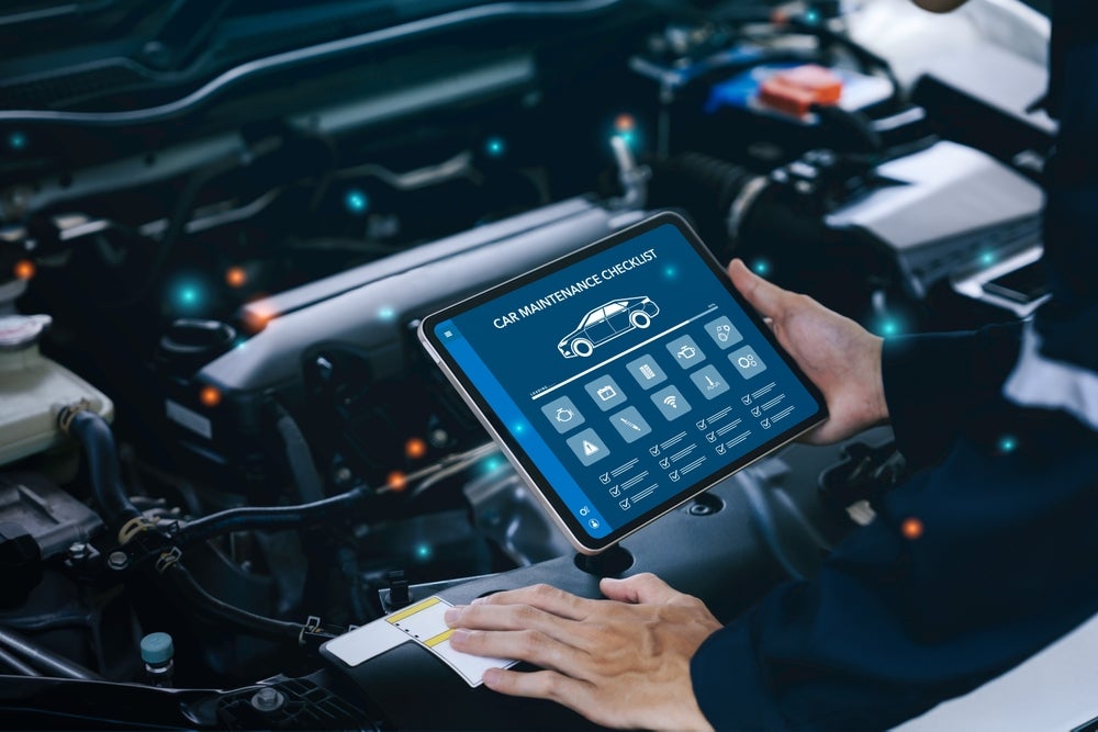 Car maintenance checklist on a technician's tablet